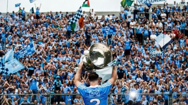 Dublin’s Philly McMahon lifts the Sam Maguire in front of Hill 16. Photograph: Tommy Dickson/Inpho