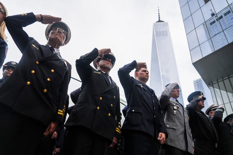 Firefighters salute during a moment of silence outside the FDNY Ten House station during the 25th anniversary commemoration of the September 11, 2001 attacks in New York on September 11, 2026. (Photo by RYAN MURPHY / AFP via Getty Images)