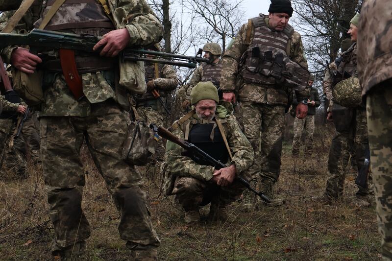 Recruits rest after drills at a training ground in the Zaporizhzhia region, Ukraine. Photograph: Andriy Andriyenko/AP