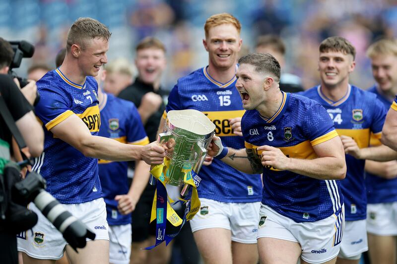 Tipperary's Bryan O'Mara and Willie Connors celebrate with the Liam McCarthy Cup. Injury meant O'Mara was the only Tipperary player not to play for his club in the week after their All-Ireland win. Photograph: Laszlo Geczo/Inpho