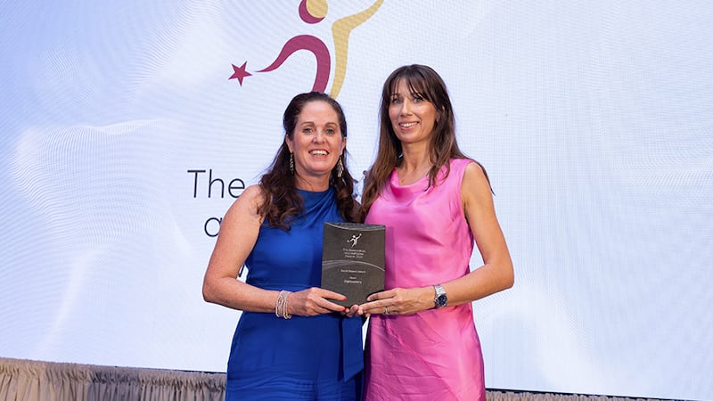 Angela Guillemet, awards judge, presents the social impact award to Esther Murphy, DigiAcademy