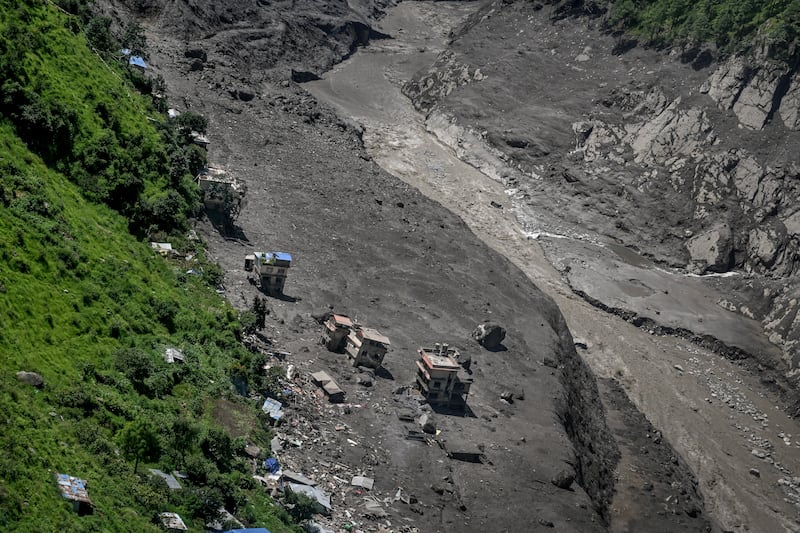 Structures damaged by the giant torrent of water, mud and ice that swept through a remote river valley in the Rasuwa district near Nepal’s border with Tibet. Photograph: Atul Loke/The New York Times
