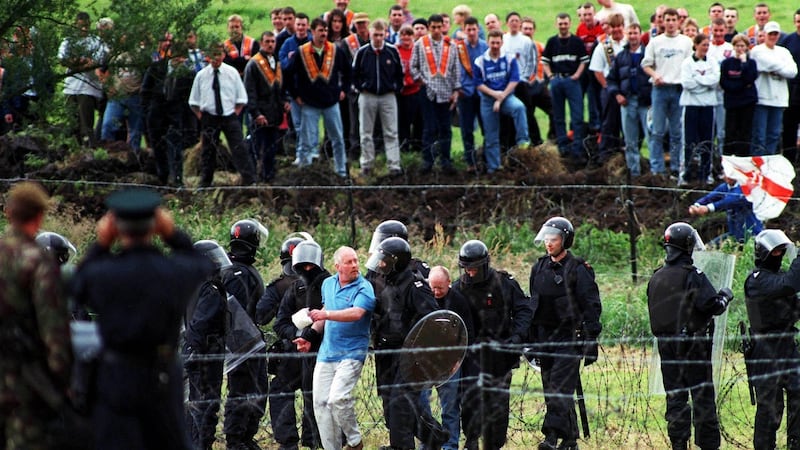 Protesting loyalists are arrested by RUC during the siege at Drumcree 1998. Photograph: Eric Luke