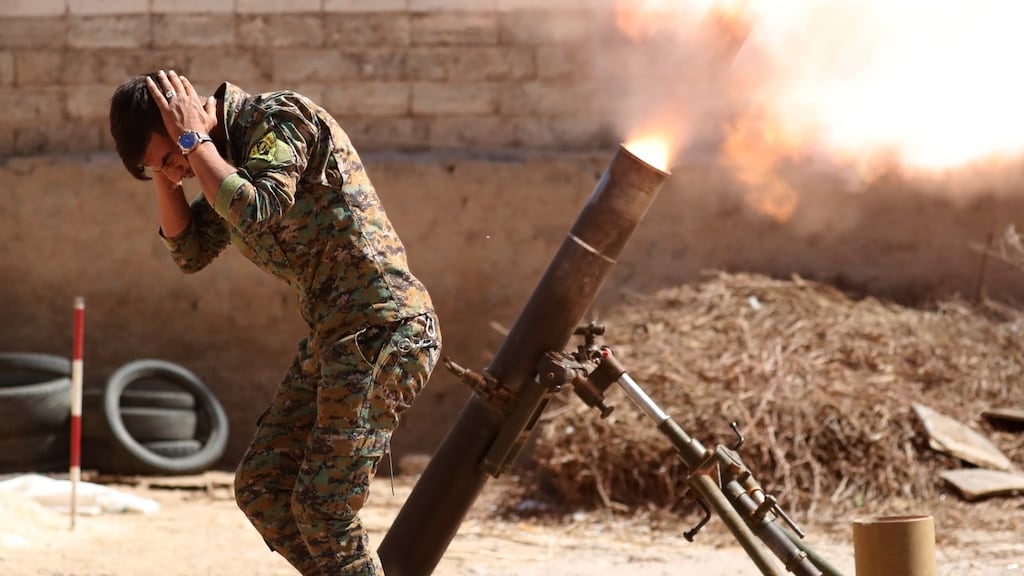 A Kurdish fighter from the People’s Protection Units (YPG) fires a 120mm mortar round in Raqqa, Syria. Photograph: Goran Tomasevic/Reuters