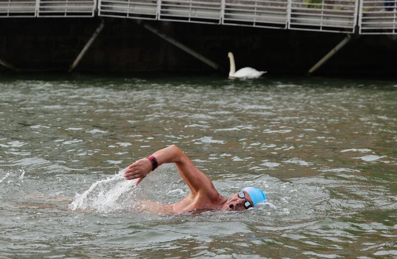 Derek Wilkes, with a swan for company, has victory in his sights. Photograph: Alan Betson
