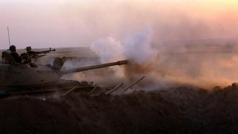 Iraqi Kurdish Peshmerga fighters fire at Islamic State militant positions from the front line in Khazer, near the Kurdish checkpoint of Aski kalak, northern Iraq Photograph: Safin Hamed/AFP Photo