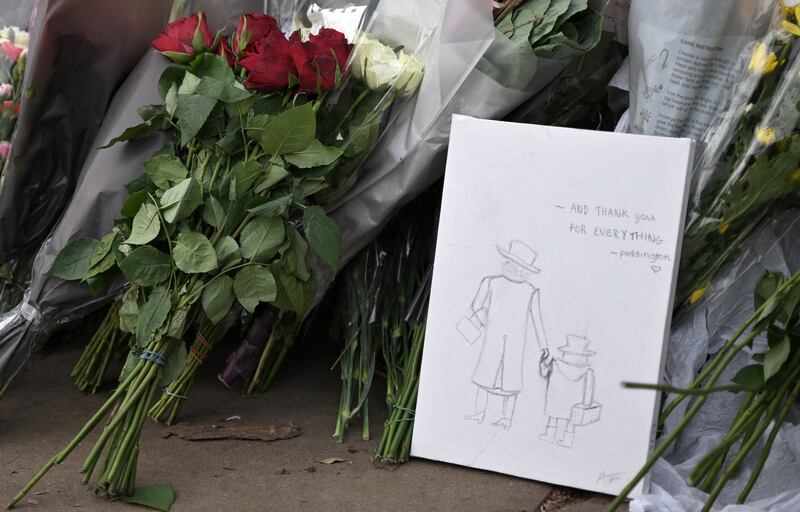 A drawing of Queen Elizabeth holding the hand of Paddington Bear. Photograph: Loic Venance via Getty Images