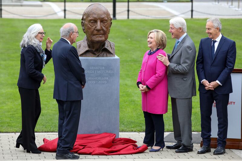 A bust of George Mitchell being unveiled in the grounds of Queen's University Belfast by his wife Heather MacLachlan as Hillary and Bill Clinton, and Tony Blair look on during the first day of the conference. Photograph: Paul Faith/AFP via Getty Images