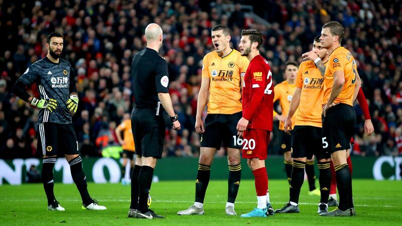 Wolves playes talk to referee Anthony Taylor after they had a goal disallowed at Anfield. Photograph: Nick Potts/PA