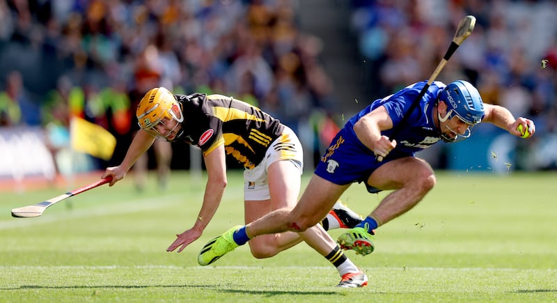 Shane O'Donnell eludes the challenge of Kilkenny's Richie Reid during the semi-final in which O'Donnell couldn't step the bleeding from a badly cut finger. Photograph: James Crombie/Inpho ames Crombie