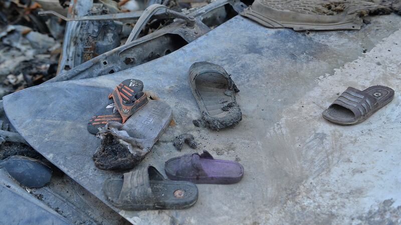 Partially burnt shoes amid the debris of the house of Ezmarai Ahmadi who was wrongly identified as an Islamic State militant by US intelligence.Photograph: Hoshang Hashimi/AFP