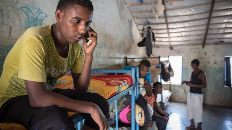 An Eritrean teenager sits on his bed in the unaccompanied minors section of Shagarab refugee camp, eastern Sudan. Photograph: Sally Hayden