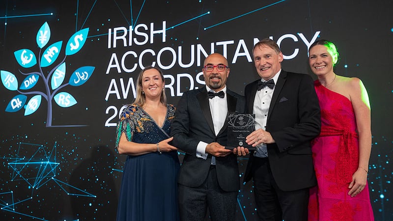 Flavio Greco, sales and marketing director at Iplicit Ireland, presents the finance project of the year award to the Fexco team