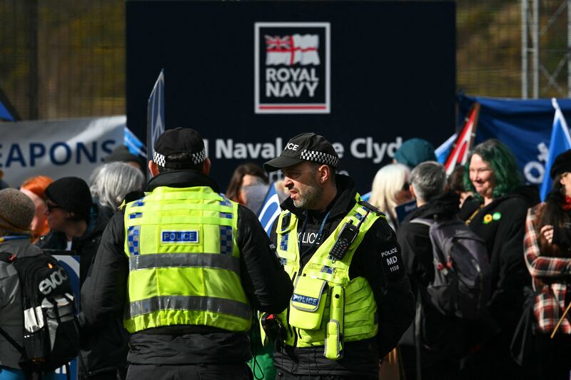 Police officers on duty as protesters demonstrate outside the Clyde naval base. Photograph: Andy Buchanan/AFP/Getty Images