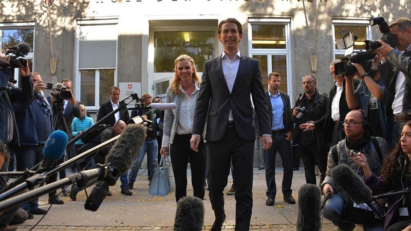 Austria’s foreign minister and leader of Austria’s centre-right People’s Party (OeVP) Sebastian Kurz  and his partner Susanne Thier leave a polling station during general elections on Sunday. Photograph: Getty