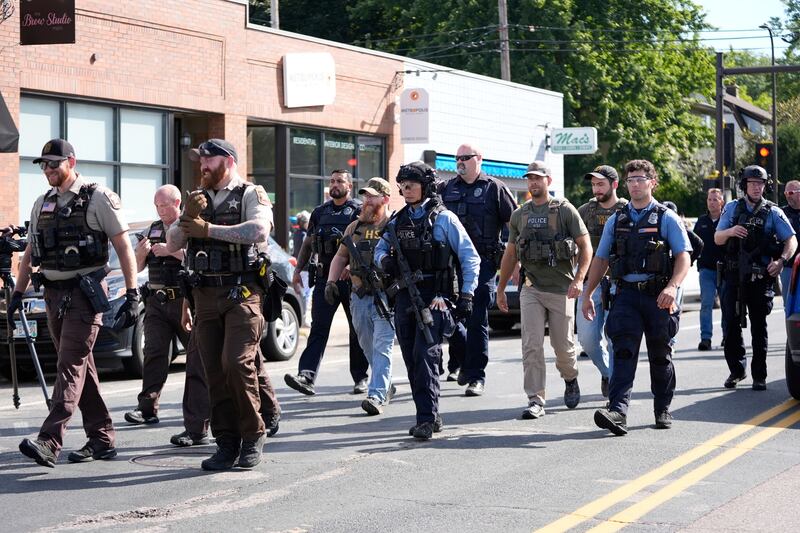 Law enforcement officers gather outside the Annunciation Catholic School in response to a shooting in Minneapolis. Photograph: Abbie Parr/AP