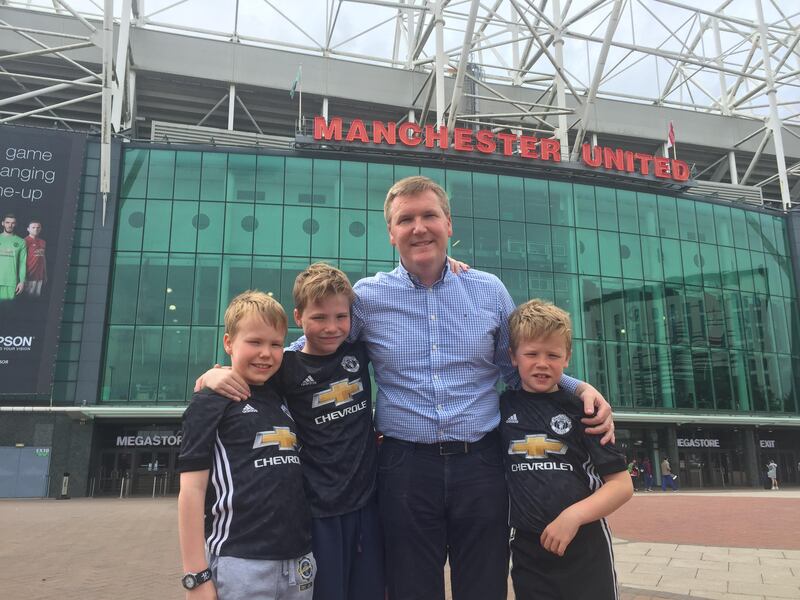 Michael with Ronan, David and Tom outside Old Trafford in Manchester.