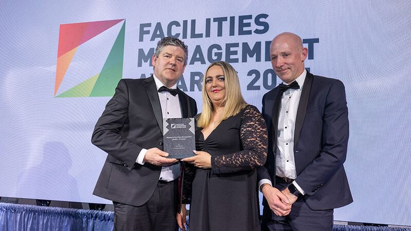 David Gormalley, director at MKF Property Services, presents the women in facilities management award - in house to Cristiana Besteliu and Ronan McDonnell, SOS Group