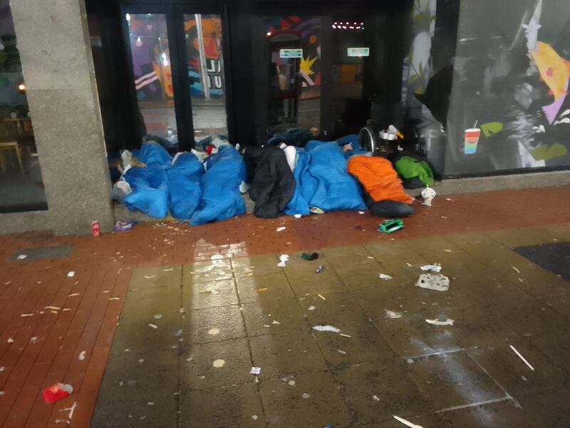 Seven people huddle in sleeping bags on Royal Avenue, Belfast’s main shopping thoroughfare. Photograph: The People's Kitchen