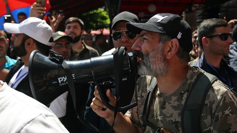 Opposition lawmaker Nikol Pashinian, right, uses a megaphone during a demonstration on Wednesday. Photograph: Thanassis Stavrakis/AP