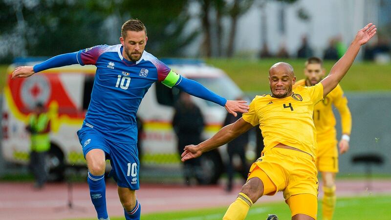 Belgium’s Vincent Kompany challenges  Iceland’s Gylfi Thor Sigurdsson  during the Nations League  match  in Reykjavik. Photograph:  Haraldur Gudjonsson/AFP/Getty Images