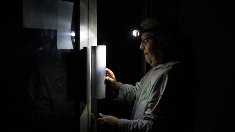 A man enters a Caracas residential building in darkness.  Sunday is the third day Venezuelans remain without communications, electricity or water, in an unprecedented power outage. Photograph:  Cristian Hernandez/AFP/Getty Images