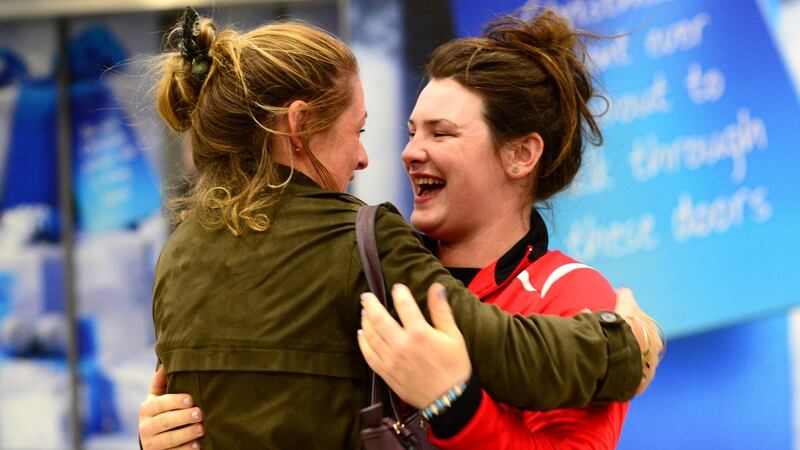 Katie Crawford (left), who came home from Kentucky this morning,  with her cousin Amy Creegan  at Dublin Airport. Photograph: Cyril Byrne/The Irish Times