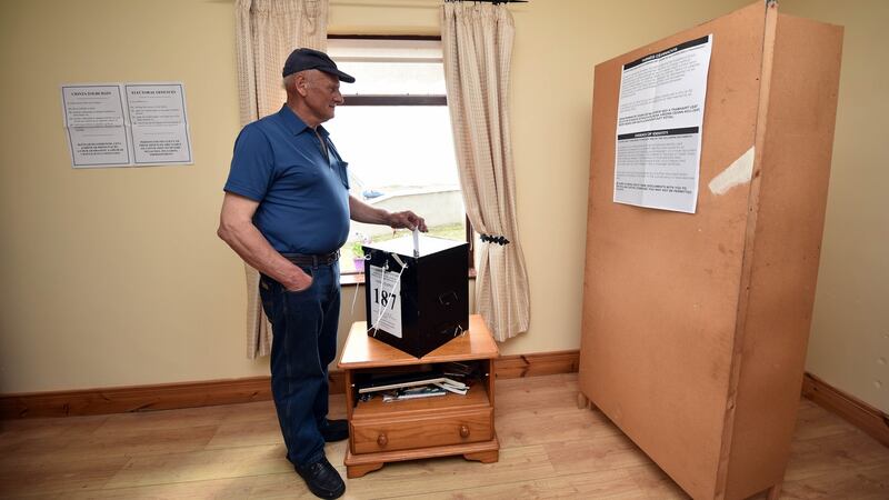 Jimmy Sweeney casts one of the first votes in the abortion referendum on  Gola Island off Donegal. Photograph:   Charles McQuillan/Getty Images