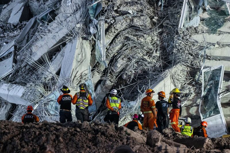 Rescue workers at the collapsed construction building in Chatuchak area in Bangkok, Thailand. Photograph: Sirachai Arunrugstichai/Getty Images