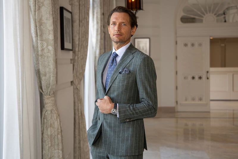 Green chalk stripe suit (€1,149) with peaked lapel. Bengal stripe shirt (€219), brown leather penny loafers (€520), from Louis Copeland