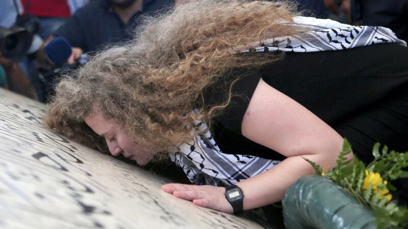 Ahed Tamimi  (17) at the grave of late Palestinian leader Yasser Arafat in the West Bank town of Ramallah on Sunday following her release from prison. Photograph: Shadi Hatem/EPA.