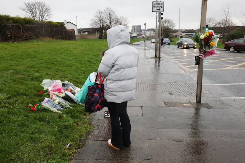 A woman and child pay their respect at the site of the incident. Photograph: Alan Betson