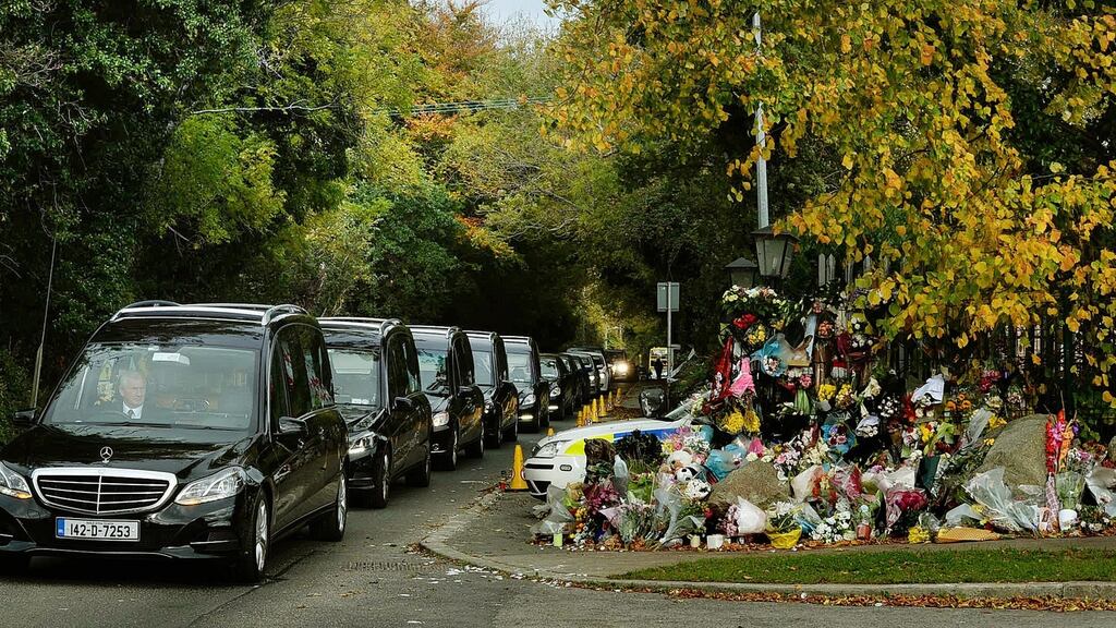 The  coffins of Thomas and Sylvia Connors and their children Christopher, Jim and  Mary pass the halting site at Glenamuck Road, Carrickmines. Photograph: Cyril Byrne / The Irish Times