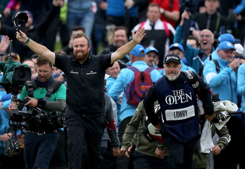 Shane Lowry on the 18th hole with his caddie Brian Martin on his way to completing his victory in the 148th Open Championship at Royal Portrush. Photograph: David Cannon/Getty 