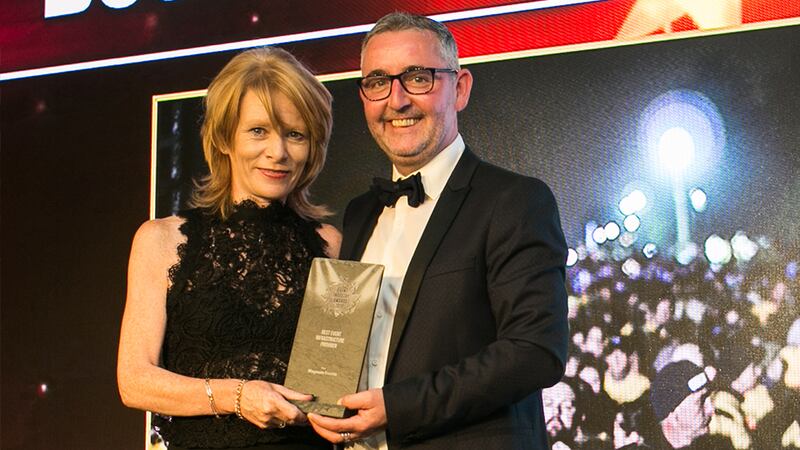 Daniel Saunders, Deputy General Manager, The Clayton Hotel presents the Best Corporate Entertainer award to XOD Team.