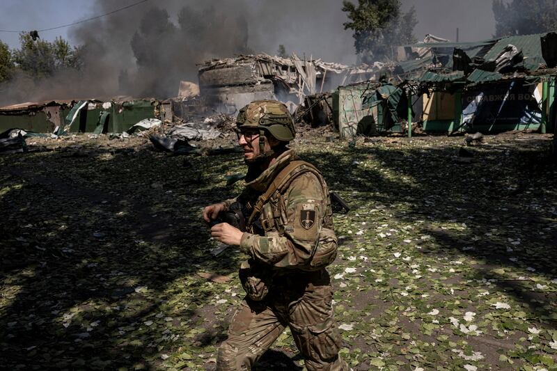 A Ukrainian soldier runs past the site where a Russian glide bomb exploded minutes earlier near the embattled city of Pokrovsk. Photograph: Finbarr O’Reilly/The New York Times