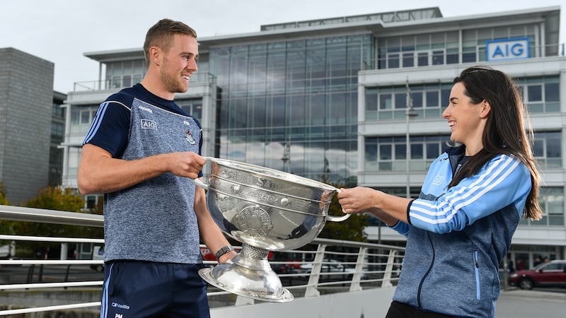 Dublin Footballer Paul Mannion and Ladies footballer Lyndsey Davey, along with the Sam Maguire and Brendan Martin Cups, were at AIG Insurance’s head office in Dublin on Tuesday to mark Dublin’s All-Ireland wins.  Photograph: Sam Barnes/Sportsfile