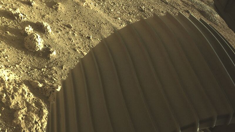 NASA handout high-resolution image showing one of the six wheels aboard NASA’s Perseverance Mars rover after it touched down on Mars on Thursday. Photograph: NASA/JPL-Caltech/PA Wire