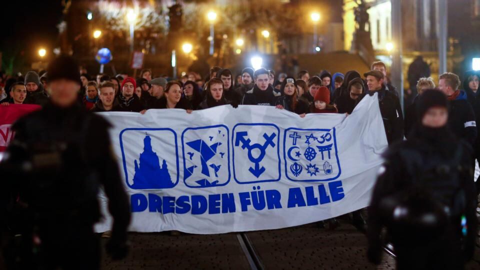 Counter protesters hold a banner which reads during a march against a demonstration of the anti-immigration group Pegida in Dresden. Photograph: Hannibal Hanschke/Reuters