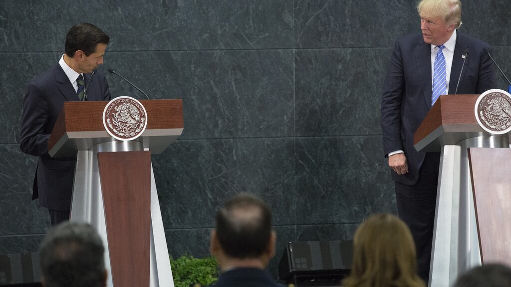 President Enrique Peña Nieto and Republican presidential nominee Donald Trump speak during a joint conference in Mexico City: Mr Peña Nieto has faced a fierce backlash at home over what many saw as his red carpet treatment of Mr Trump. Photograph: Susana Gonzalez/Bloomberg