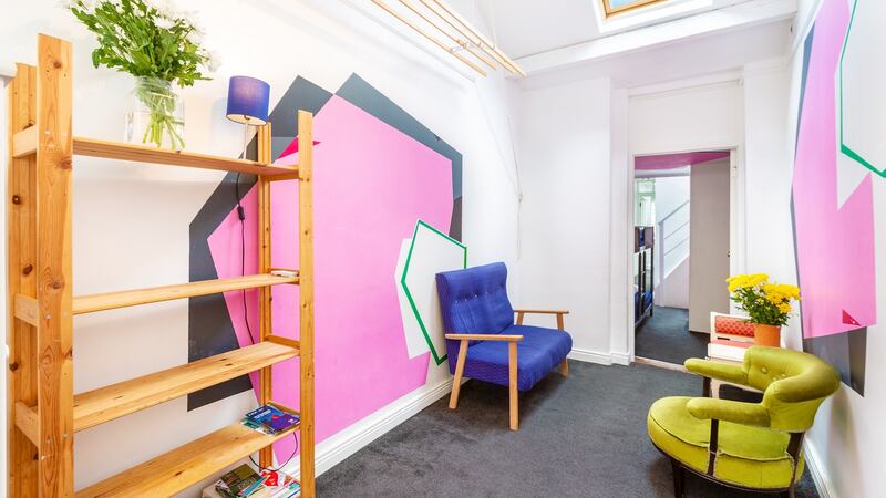 The owners used  Paul Monaghan’s murals to enhance the illusion of space in both the living and dining areas
