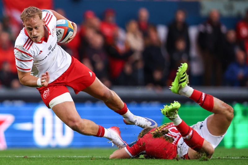 Munster's Mike Haley trips over Sam Costelow of Scarlets. Photograph: Ben Brady/Inpho