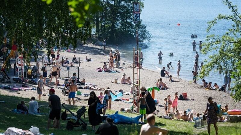 People at a lake beach in Stockholm last month; Sweden decided not to ban public gatherings or require social distancing. File photograph: Getty Images