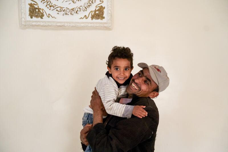 Nabil playing with his son Mohammed who has recovered from cholera. Photograph: Alsunaidar/Unicef, Yemen, 2023