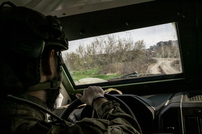 A Ukrainian soldier drive through western Bakhmut. Photograph: Mauricio Lima/New York Times