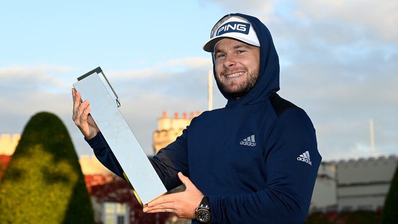 Tyrrell Hatton of England wearing his hoodie and holding the  trophy after the final round of the BMW PGA Championship at Wentworth Golf Club. Photograph: Ross Kinnaird/Getty Images