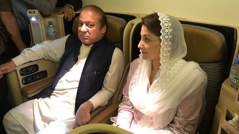 Former prime minister Nawaz Sharif and his daughter Maryam Nawaz await arrest on an aircraft after their arrival in Lahore. Photograph: PML-N/Getty Images