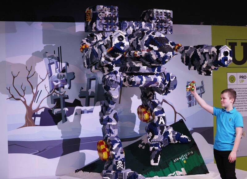 Finn Ryan  and the Timber Wolf Mech sculpture at the ehibition. Photograph: Leon Farrell/Photocall Ireland