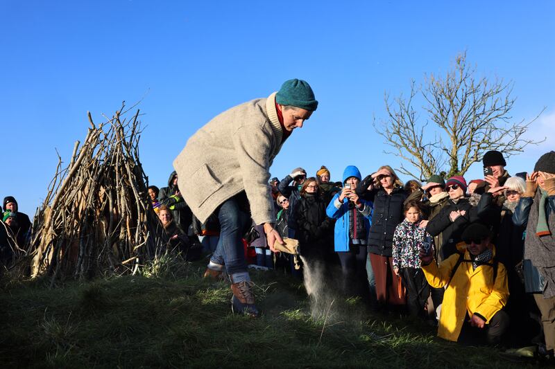 Aisling Rogerson scatters her late husband Manchán's ashes at his month’s mind. Photograph: Dara Mac Dónaill 










