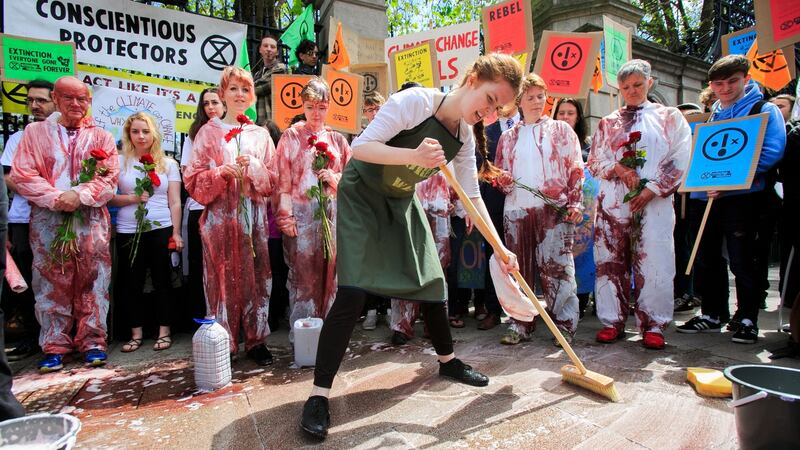 Members of Extinction Rebellion Ireland playing characters of characters of Innocents, Politicians and Green-washers during a Blood on our children protest by Extinction Rebellion. Photograph: Gareth Chaney/Collins
